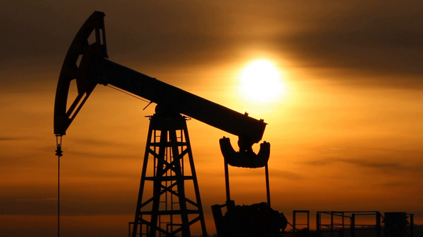 Oil production. Oil pumps at sunset - Footage, Video