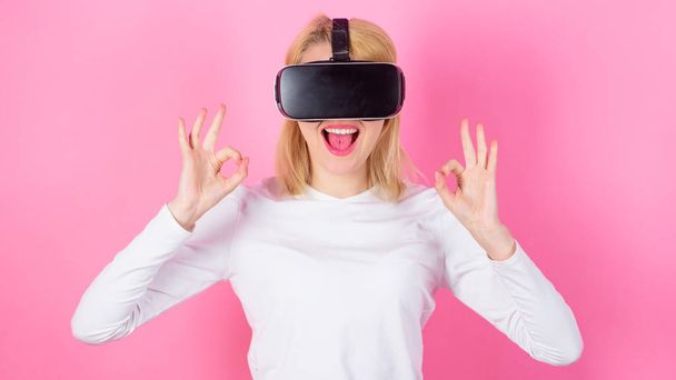Virtual reality and future technologies. Girl use modern technology vr headset. Interact alternative reality. Digital device benefits. Woman head mounted display pink background. Alternative space - Foto, afbeelding
