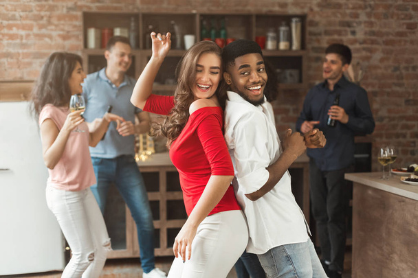Happy interracial couple dancing at home party - Photo, Image
