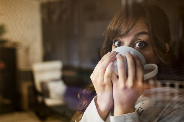 woman is drinking a cup of coffee - Φωτογραφία, εικόνα