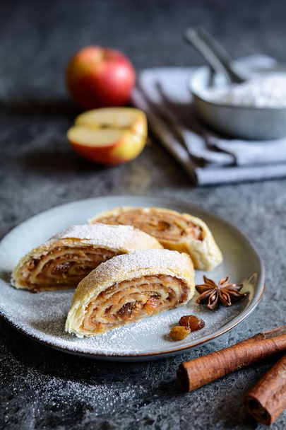 Slices of traditional apple roulade with raisins and cinnamon - Photo, Image