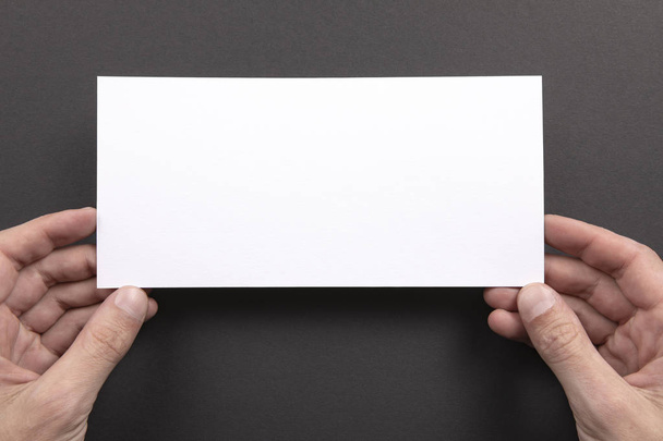 Mens hands holding white flyer - Foto, Imagem