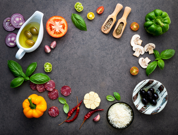 The ingredients for homemade pizza on dark stone background. - Photo, Image