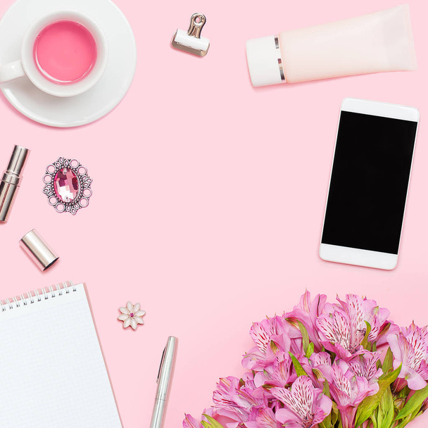 Home office workspace  with copyspace. Flat lay, magazines, social media. Top view Beauty blog concept. Woman fashion accessories, phone on pink background. - Photo, Image