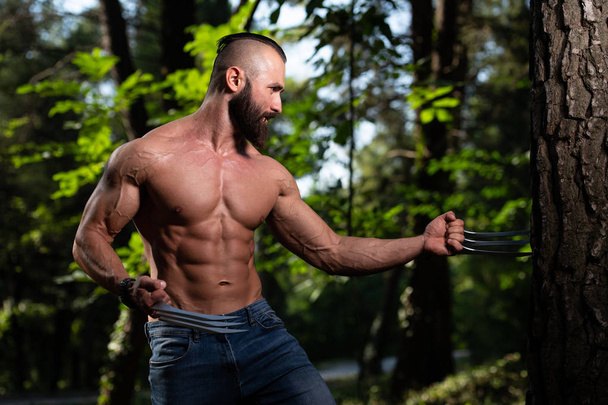 Wolverine With Claws Standing Strong Outdoors and Flexing Muscles - Athletic Superhero Posing - Foto, Bild