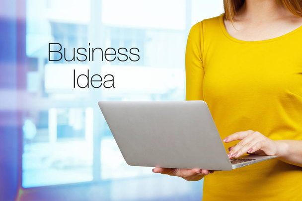 Woman typing on laptop with Business Idea on background  - Zdjęcie, obraz