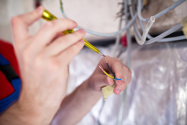 Handyman doing voltage checking with insulated screwdriver  - Photo, Image