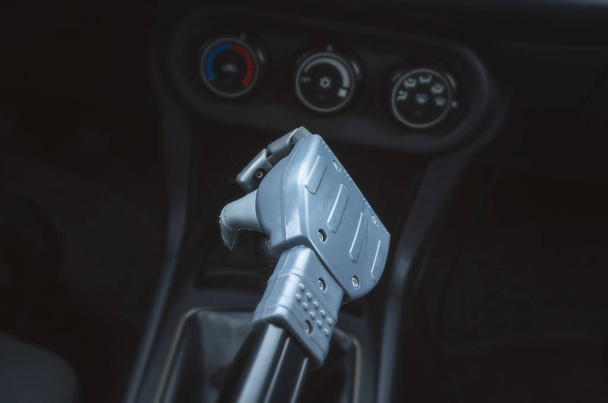 Robot hand on car gearstick. Robot pilot is driving a car. Automatic driver concept. - Photo, image