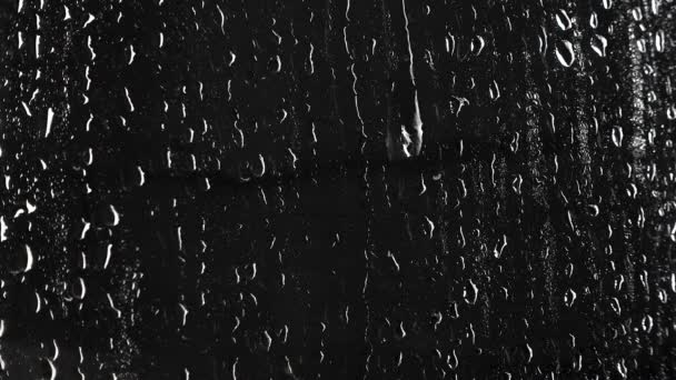 Textura de gotas líquidas sobre fondo negro
 - Metraje, vídeo