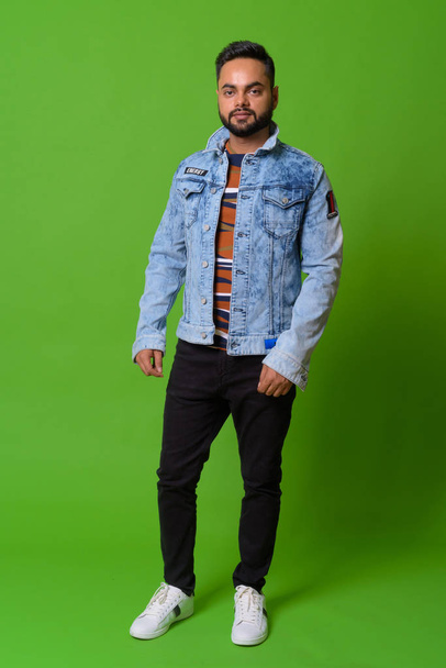 Young bearded Indian man against green background - Foto, Imagem