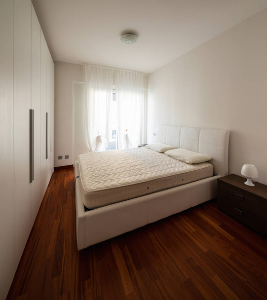 Bedroom with large wardrobe and bright window. Nobody inside - Foto, immagini