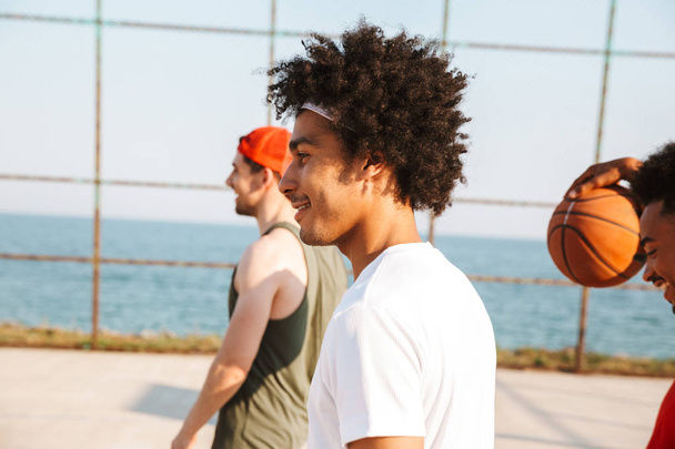 Group of multhiethnic young men at the basketball field - Φωτογραφία, εικόνα