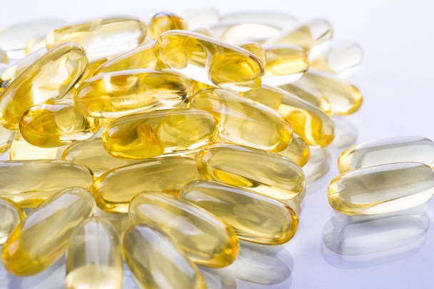 Supplementary food background. Fish oil transparent capsules. Omega 3. Vitamin E.  - Foto, afbeelding