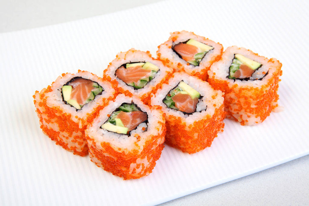 Sushi. Rolls with shrimp. Roll California with avocado. Japanese food. Healthy food is nicely laid out on a platter. Dish with rice. - Photo, Image