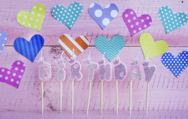 Pink Birthday Candles on a Pink  Wooden Background.Happy Birthday Concept - 写真・画像