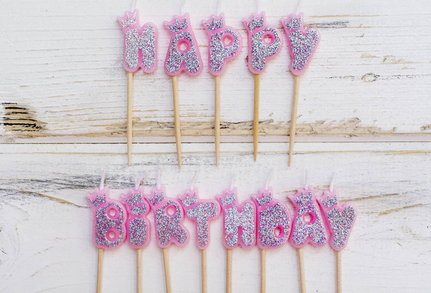 Pink Birthday Candles on a White Wooden Background.Happy Birthday Concept - Zdjęcie, obraz