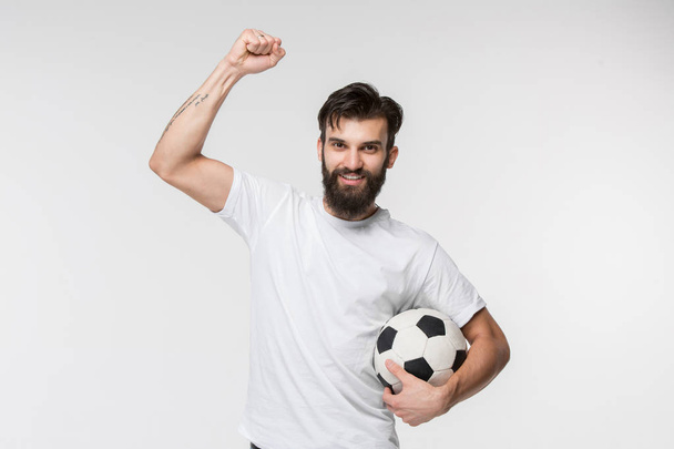 Young soccer player with ball in front of white background - Fotografie, Obrázek