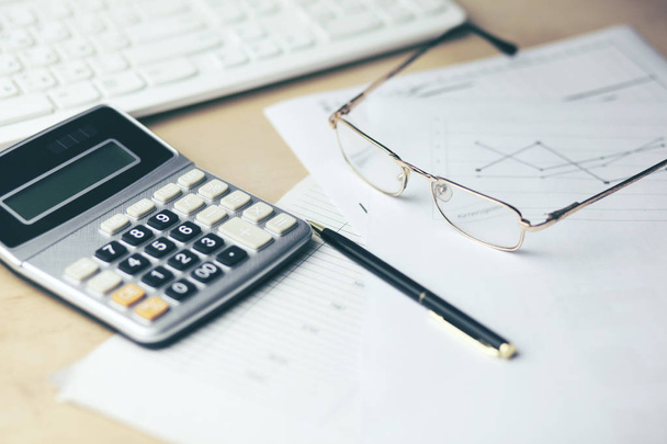 calculator with documents and keyboard on office table   - Φωτογραφία, εικόνα