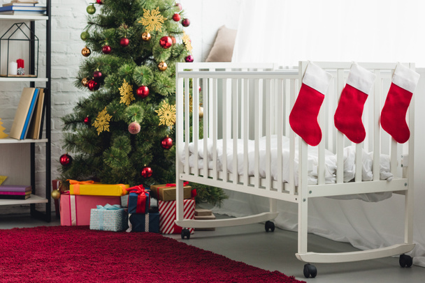 interior of christmas decorated baby room with infant bed - Foto, imagen