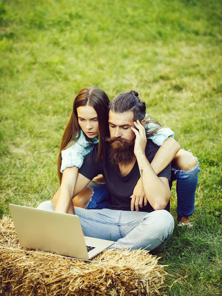 couple in love using laptop on nature - Zdjęcie, obraz