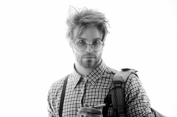 Study and knowledge. Handsome man or smart, male student, businessman, with beard and stylish, blond hair, in nerd glasses and checkered shirt with suspenders - Foto, Imagen