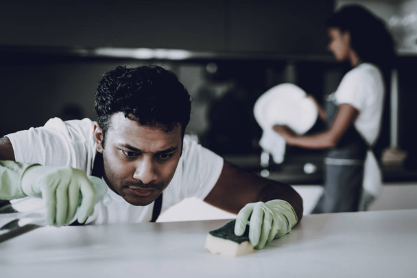 Afro American Couple Kitchen Cleaning Concept. Dish Washing. Table Cleaning. Protective Green Gloves. Household Problem. Dust Wipe Cleaner. Housecleaning Weekend. Healthy Lifestyle. - Foto, imagen