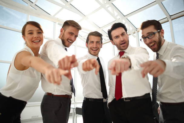successful business team standing in the office and pointing at you - 写真・画像