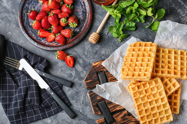 Composition with delicious Belgian waffles and strawberries on table - Photo, Image