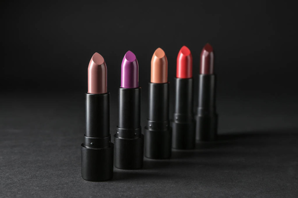 Colourful lipsticks on black background - Photo, Image