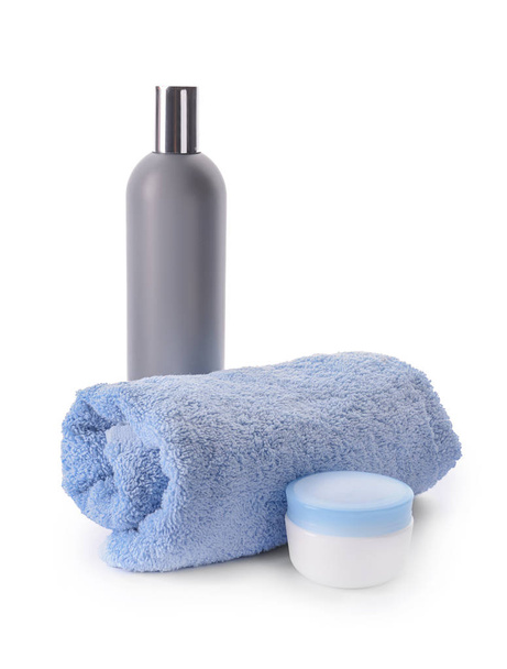 Rolled clean towel and cosmetics on white background - Photo, Image