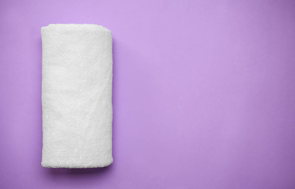 Rolled clean soft towel on color background - Photo, Image