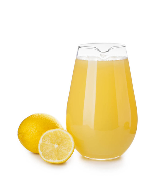 Glazen kan van vers citroensap op witte achtergrond - Foto, afbeelding