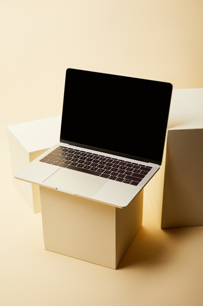 close-up shot of modern laptop with blank screen on beige cubes - Photo, Image