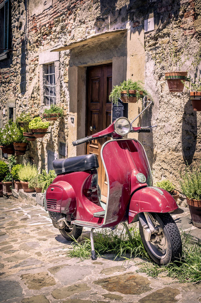 Scooter in front of old building in Cortona town, Tuscany - Fotó, kép