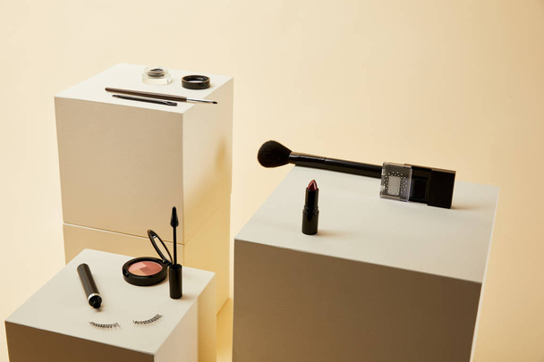 various makeup accessories kit on beige cubes - Photo, Image