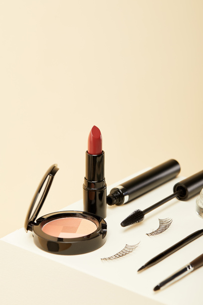 close-up shot of makeup supplies kit on beige - Фото, зображення