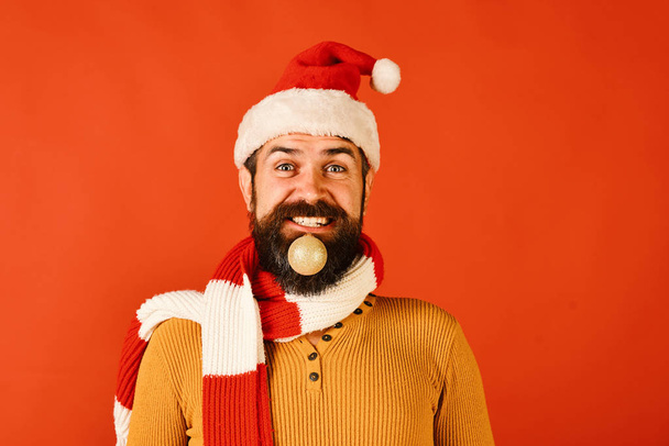 Santa Claus holds golden ball for fir tree in beard - Φωτογραφία, εικόνα