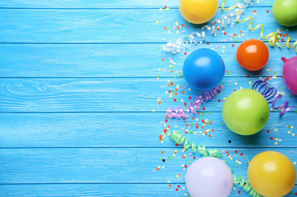 Colorful balloons with confetti on blue wooden background - Zdjęcie, obraz