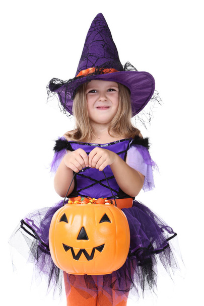 Young girl in halloween costume with pumpkin bucket on white background - Fotoğraf, Görsel