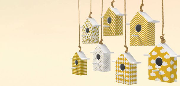Un conjunto de pajareras pintadas están suspendidas en una cuerda. Casas de pájaros con patrones amarillos y blancos aislados sobre un fondo amarillo claro con espacio para el texto. Renderizado 3D
 - Foto, Imagen