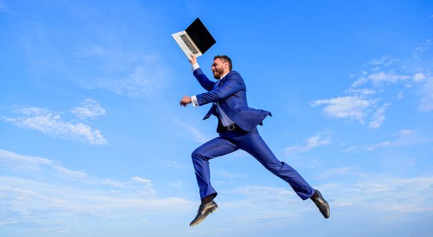 Businessman formal suit fly in air with laptop blue sky background. Heavenly online support. Excellent internet provider raise up quality connection. Businessman fly in sky as angel. Divine manager - Zdjęcie, obraz