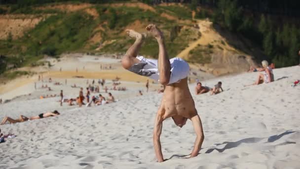 Young man dancing on beach. - Video