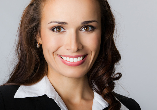Happy smiling young businesswoman, on gray - Фото, зображення