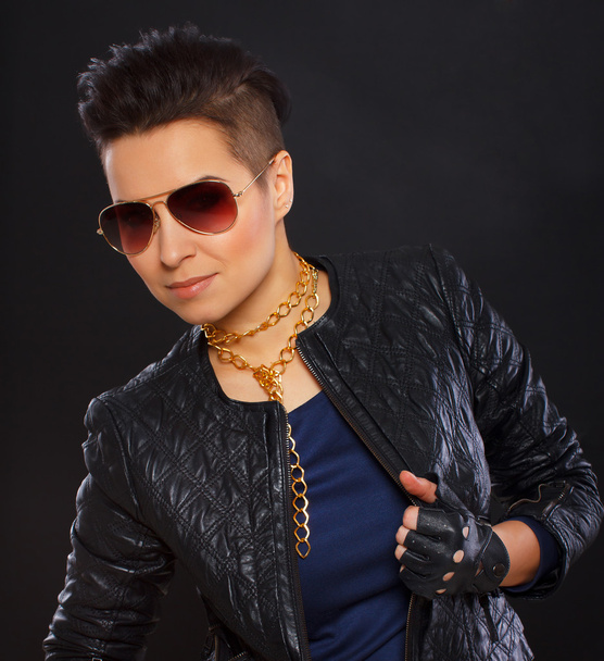 Hot rock chick is posing and demonstrating her jacket - Zdjęcie, obraz