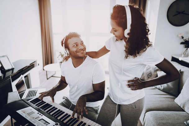 Afro American Couple Listening With Headphones Synthesizer Playing. Happy Songwriter. Morning Leisure. Digital Format Sound Record. Working Musician. Musical Hobby. Hands On Keyboard. - Fotografie, Obrázek