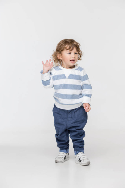 Portrait of happy joyful running beautiful little boy, studio shot on white - Fotoğraf, Görsel
