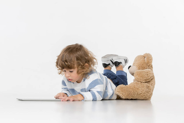 Portrait of happy joyful beautiful little boy sitting with laptop - Foto, Bild