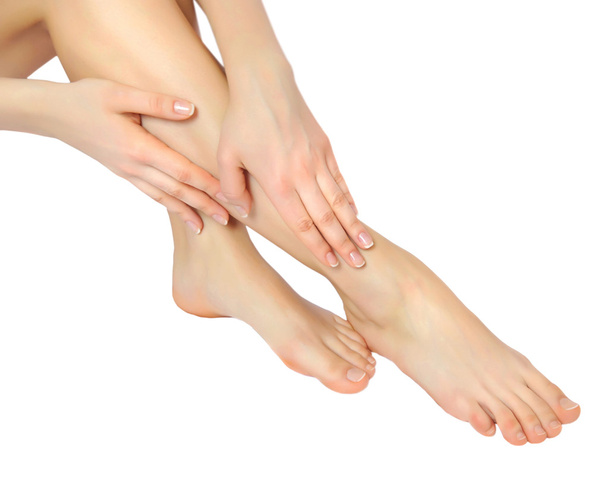 Well-groomed hands on female feet isolated on white - Foto, Imagen