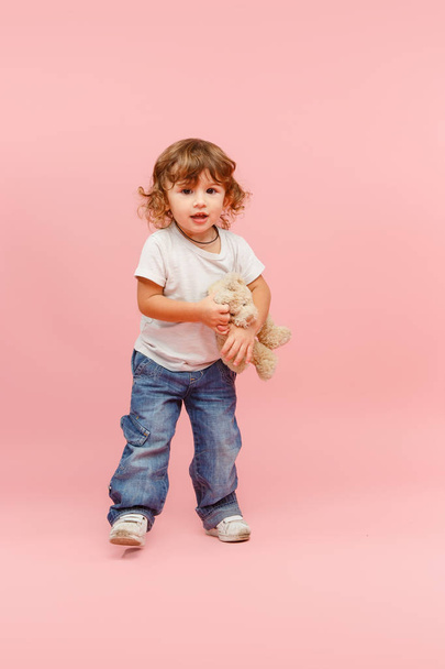Portrait of happy joyful beautiful little boy, studio shot on pink - Fotó, kép