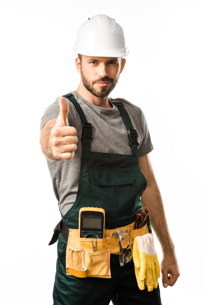 handsome electrician showing thumb up and looking at camera isolated on white - Photo, Image